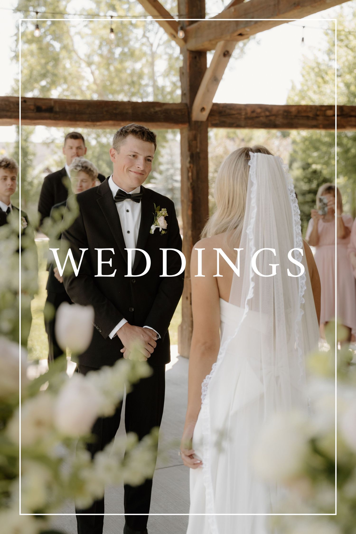 Wedding photo with couple holding bouquet in mountain meadow with text overlay.