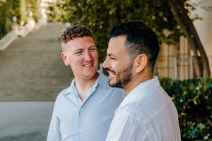 Gay couple hugging during engagement session in Montjuïc Park