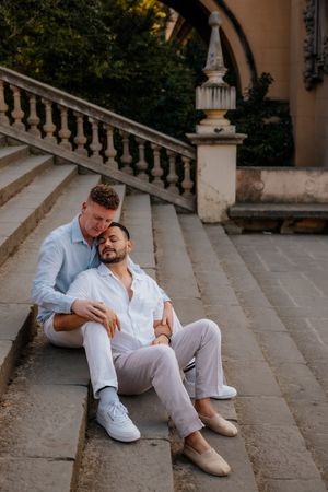Same-sex couple smiling after engagement in Montjuïc gardens