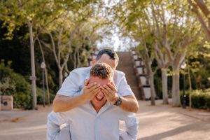 Emotional gay proposal under palm trees in Montjuïc
