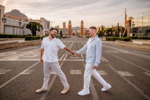 Gay couple holding hands during surprise proposal in Montjuïc Gardens