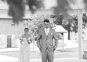 Black and white sequence showing a person in a grey suit posing outdoors.
