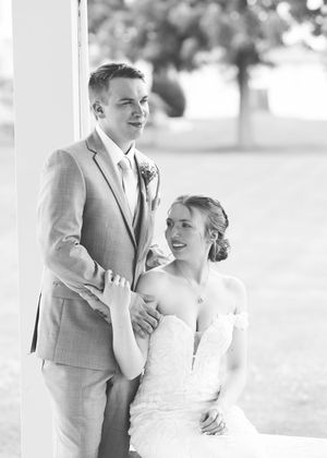Black and white wedding photos capture tender moments between newlyweds.