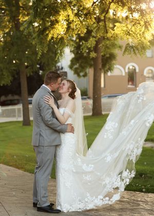 A romantic wedding photo sequence showing a couple in a lush garden setting with a flowing veil at sunset.
