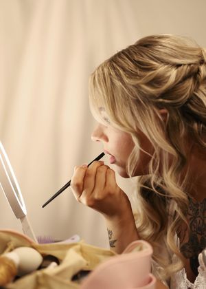 Wedding day makeup preparation captured in artistic profile shots.