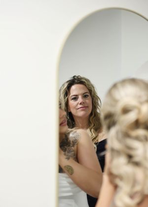 Getting ready moments captured through elegant archways in a bridal suite.