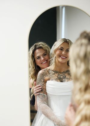 Candid pre-wedding moments shared in a bright white bridal suite.