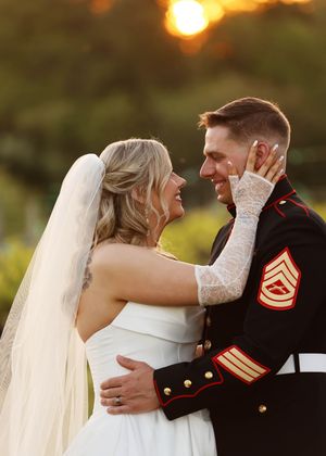 Romantic sunset wedding portrait with a Marine in dress blues uniform.