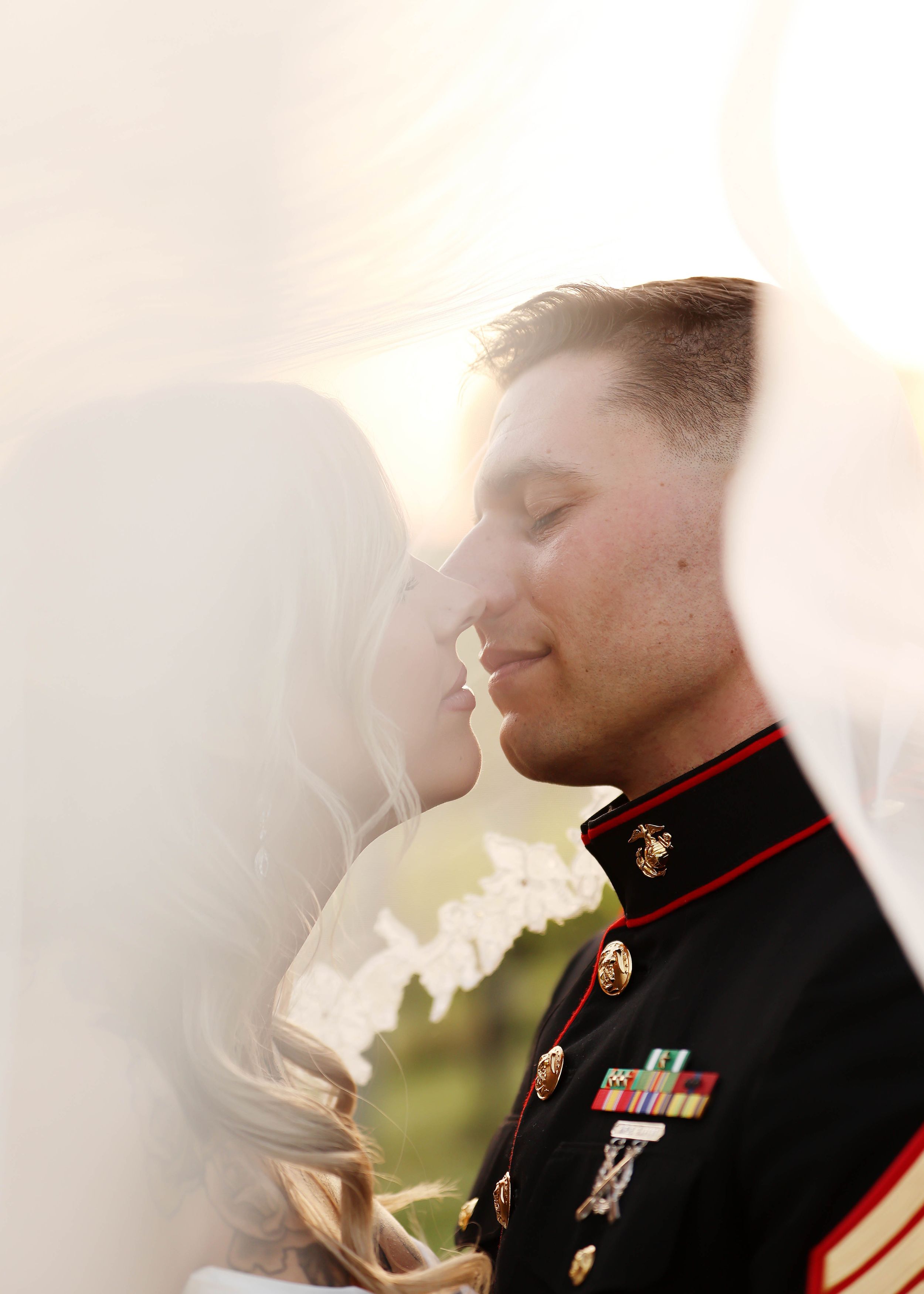 Ethereal wedding portrait with soft lighting and Marine dress blues uniform.