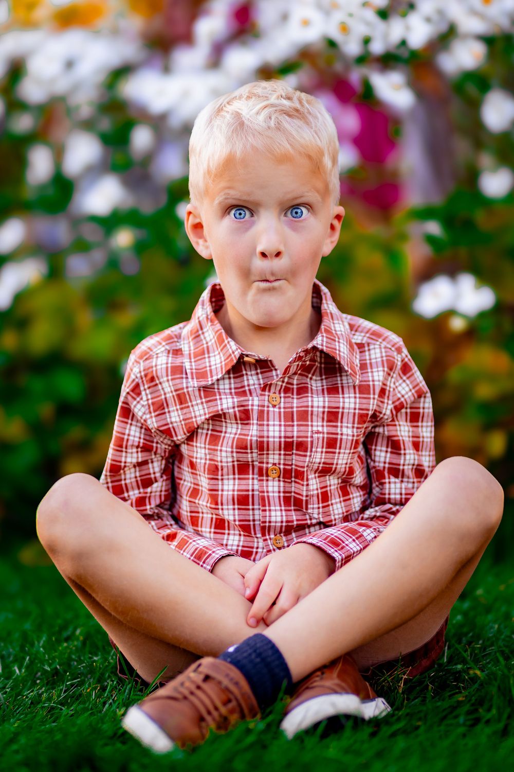 Child smiling in natural light with soft warm colors and a joyful expression.