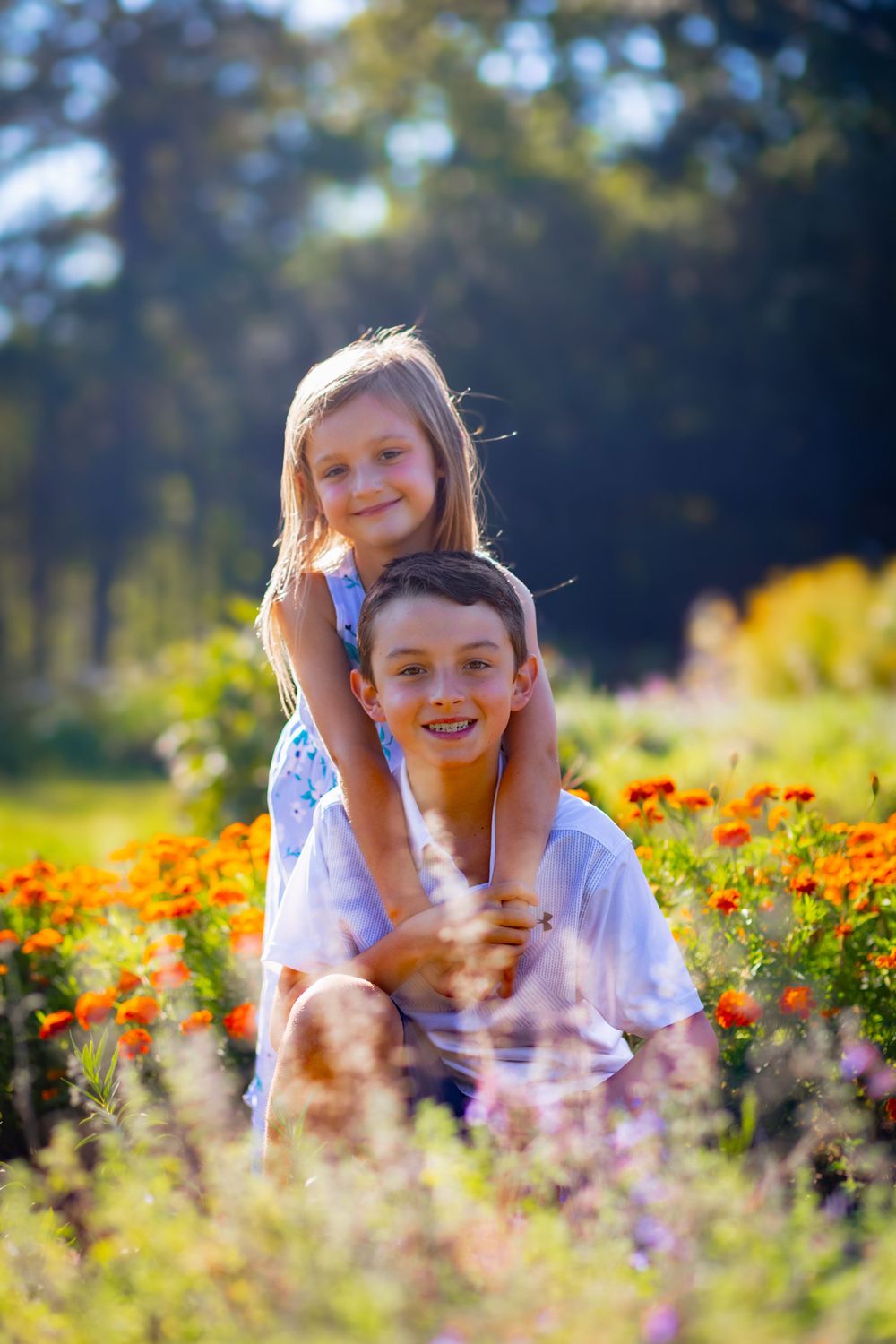 a brother and sister pose lovingly