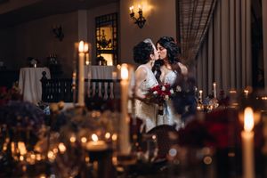 Elegant wedding reception venue with warm candlelight and string lights creating a romantic atmosphere.