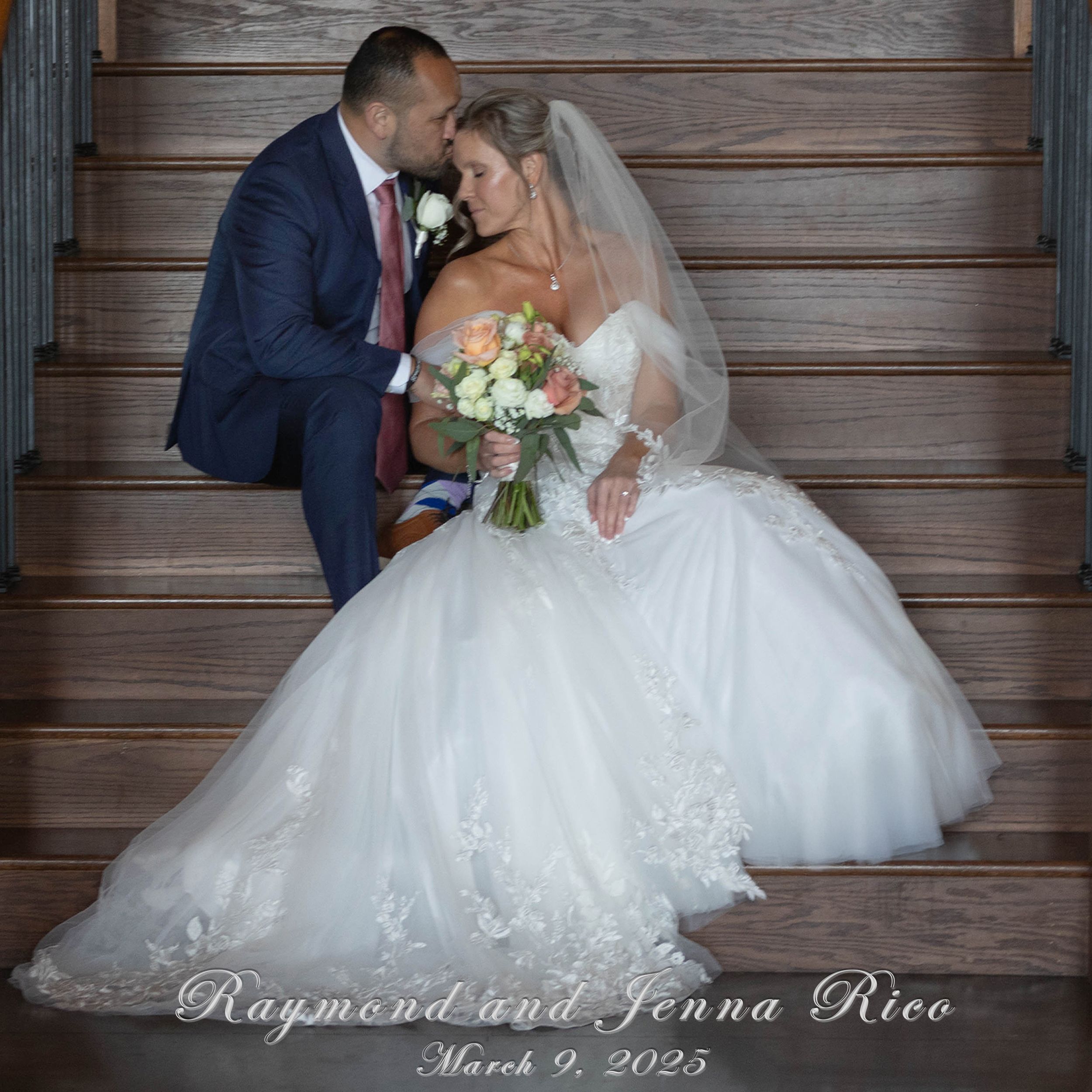 A romantic wedding couple sharing an intimate moment against rustic wooden walls with a beautiful bridal bouquet.