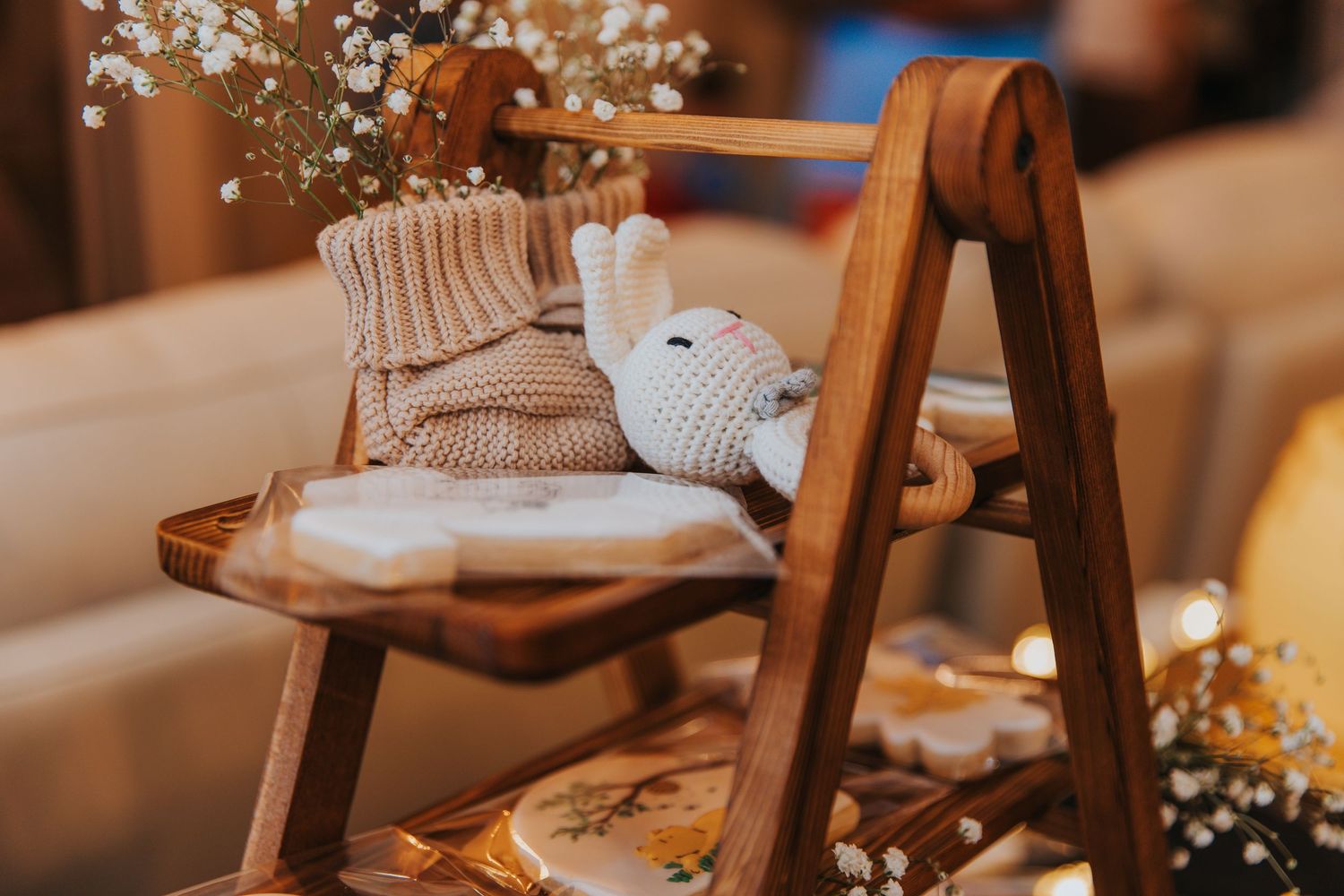 Rustic wooden chairs decorated with floral arrangements at a wedding venue.