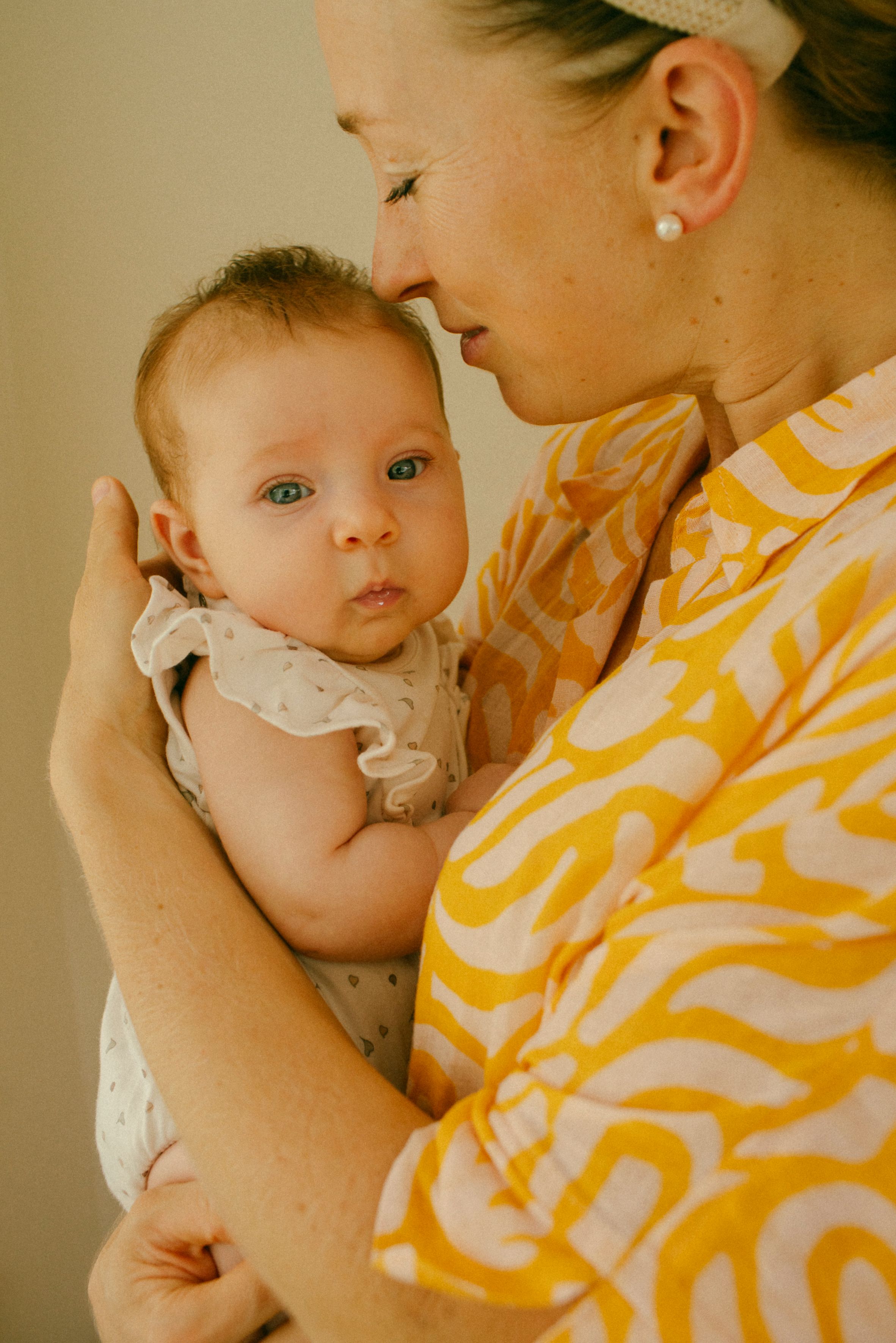 Few-month-old baby enjoying a lifestyle newborn session at home in Sydney & Northern Beaches, capturing genuine, playful, and tender family