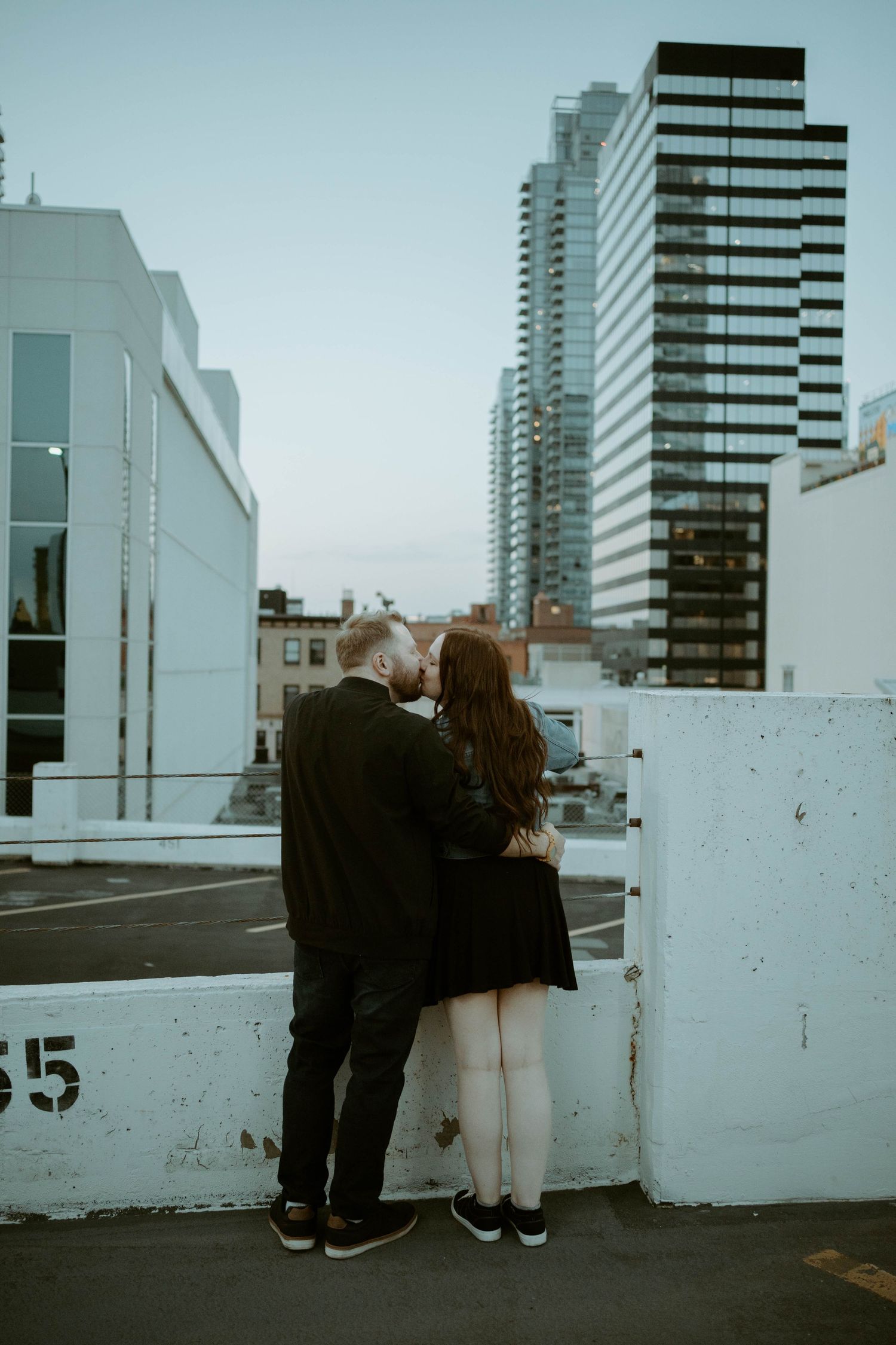 Four sequential urban rooftop photos showing a couple looking out at city buildings in moody lighting.