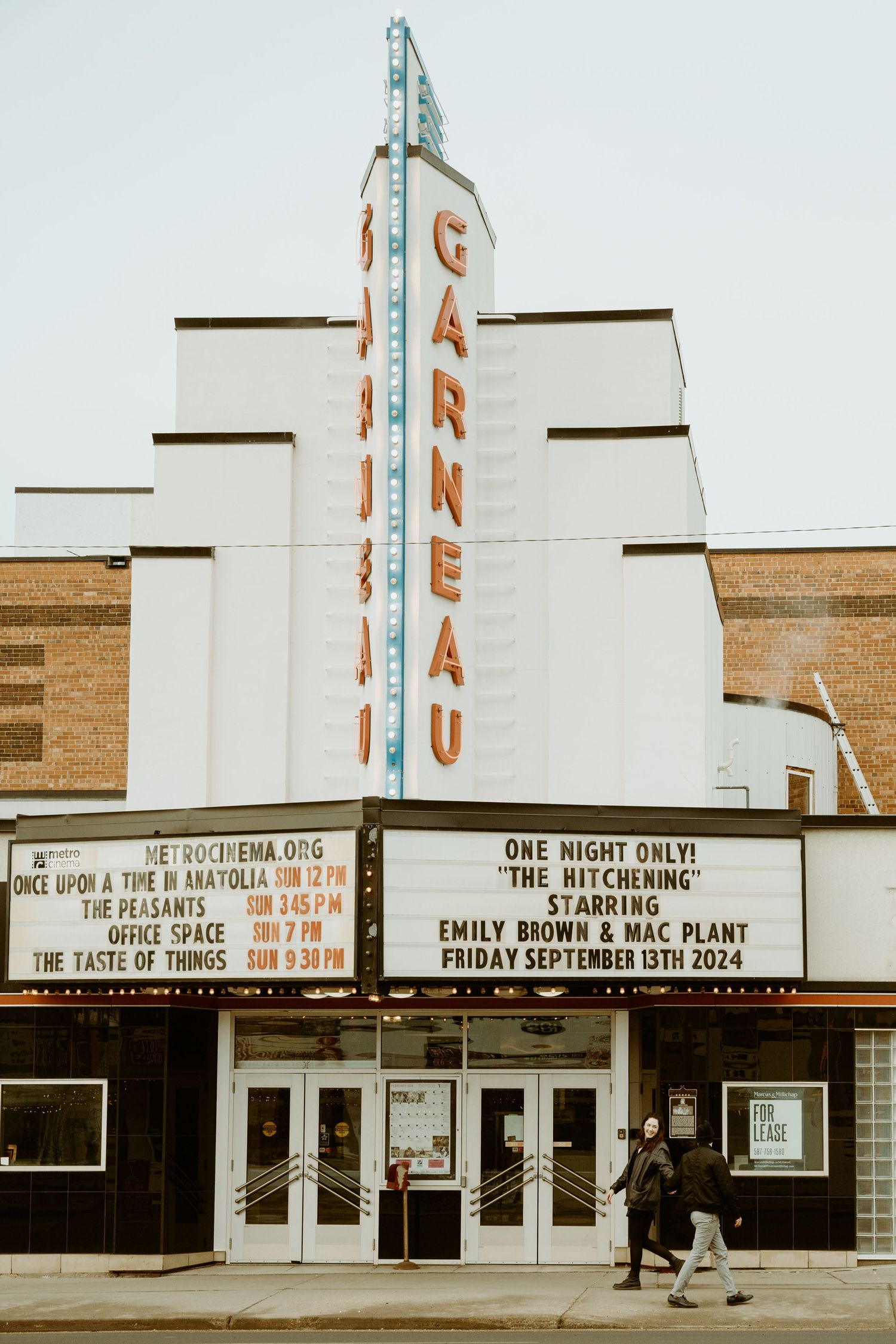 Vintage art deco Garneau Theatre marquee and facade with upcoming show details displayed.