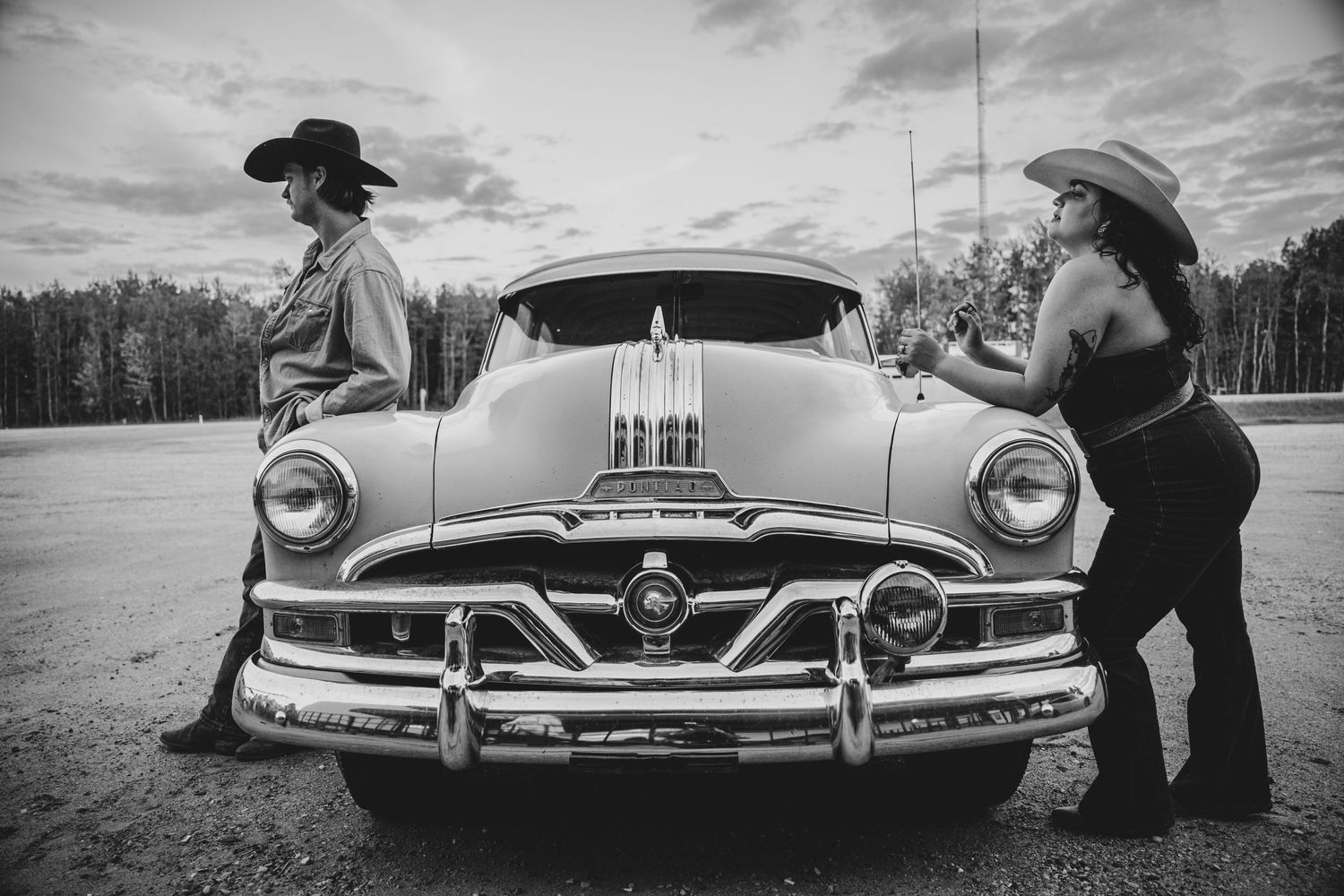 A vintage Pontiac car with chrome details photographed in black and white.