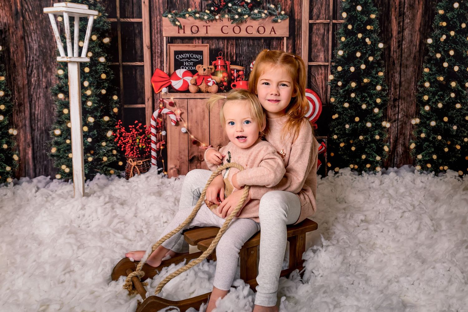 Little boy sat on Sleigh in a Christmas theme photoshoot
