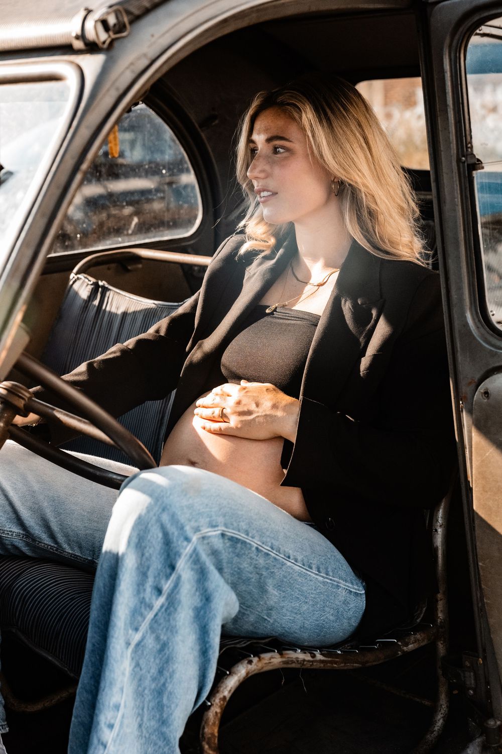 Zwangere vrouw in een oldtimer tijdens een stoere zwangerschapsshoot
