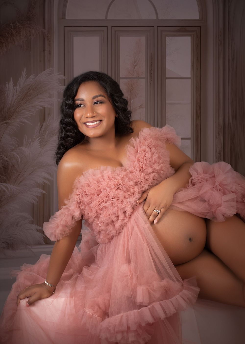 Glamorous boudoir photography featuring a pink tulle gown against an elegant vintage interior setting.