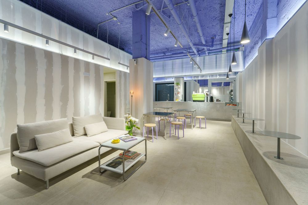 Modern office interior with white walls and furniture featuring sleek design elements and ambient lighting.