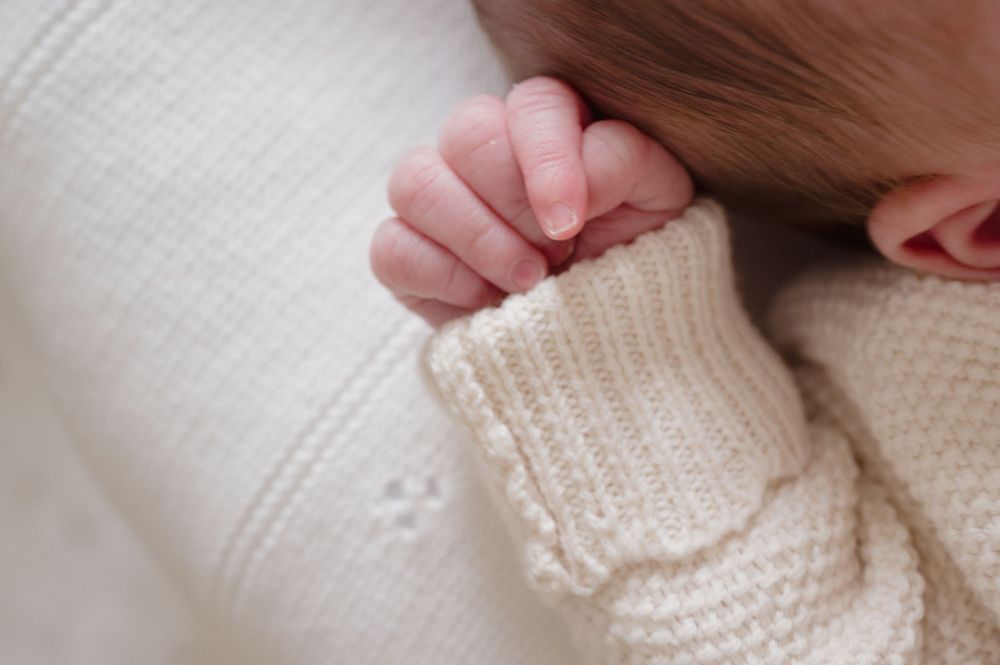 A series of close-up shots showing a baby close up in a knitted jumper.