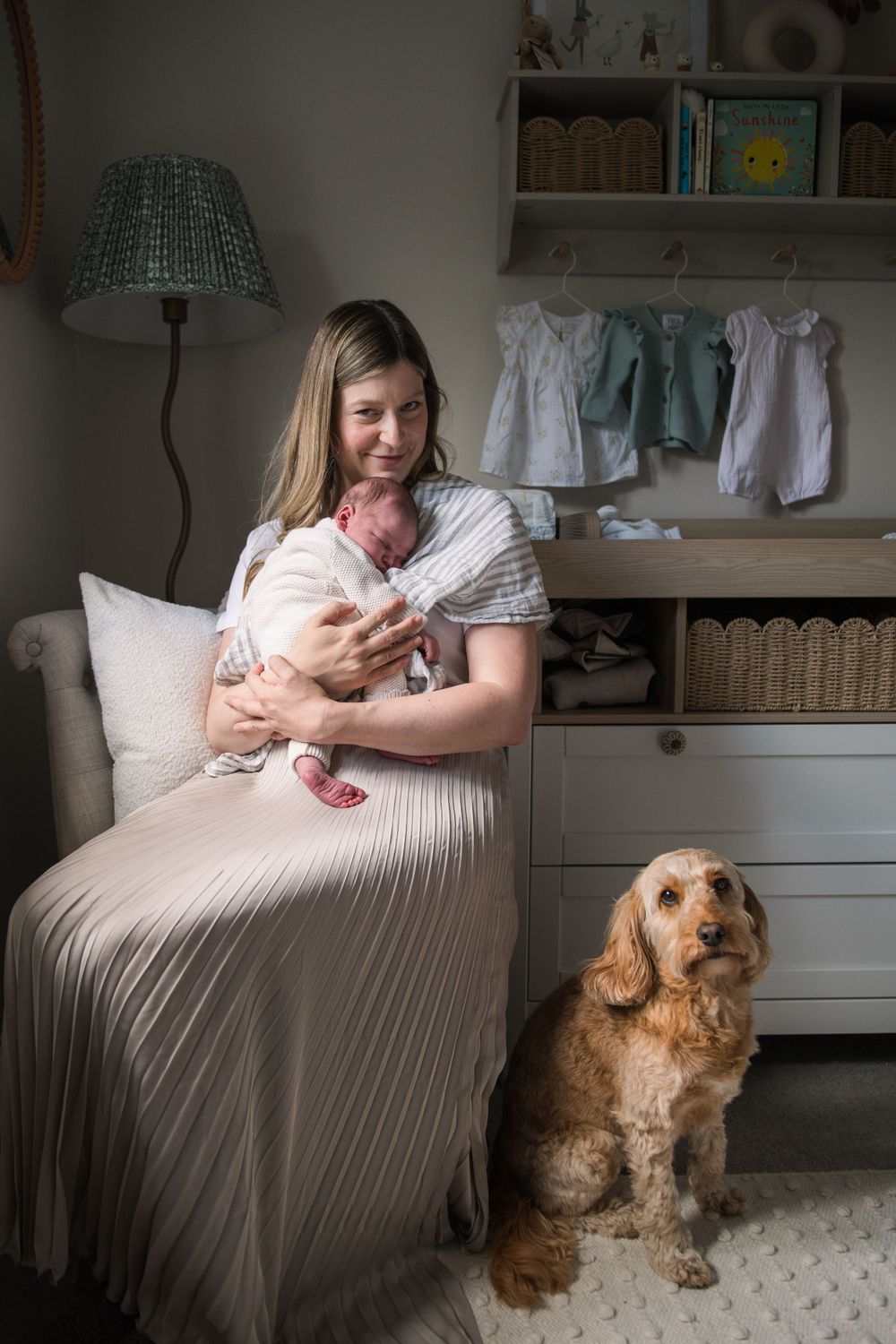 A series of photos showing a family with a fluffy brown dog sitting together on a couch in a bright nursery room.