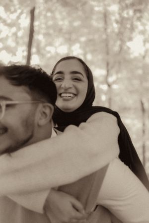Black and white intimate portrait of couple sharing joyful moment.