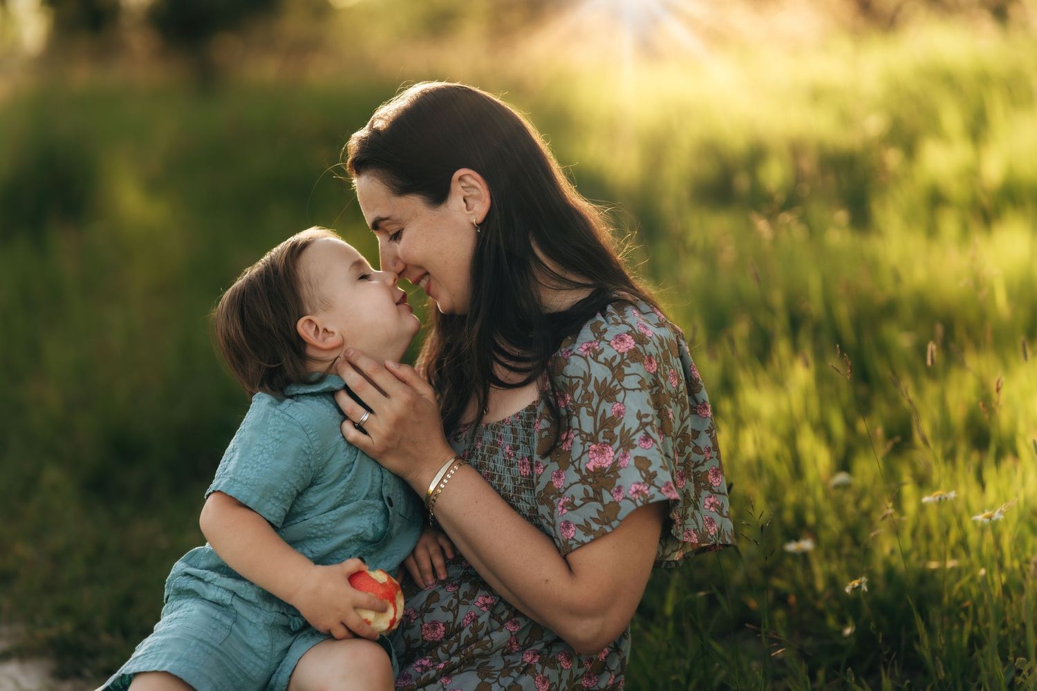 Mother and son, radiant light, wholesome, apple