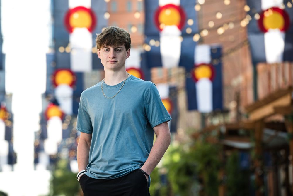 Urban portrait with colorful lanterns and city lights in background.
