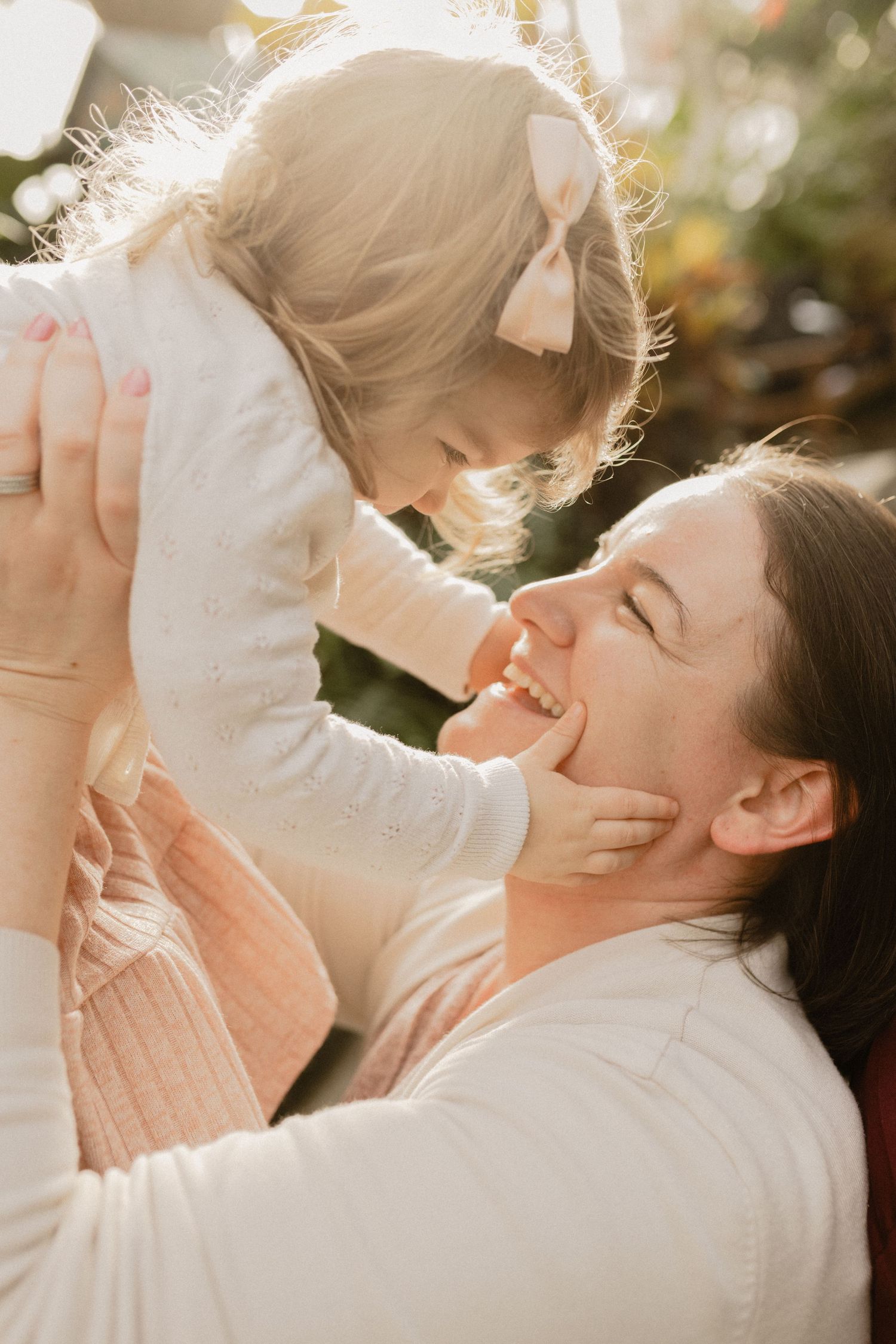A joyful outdoor photo session with expressions of love and laughter in warm sunlight.
