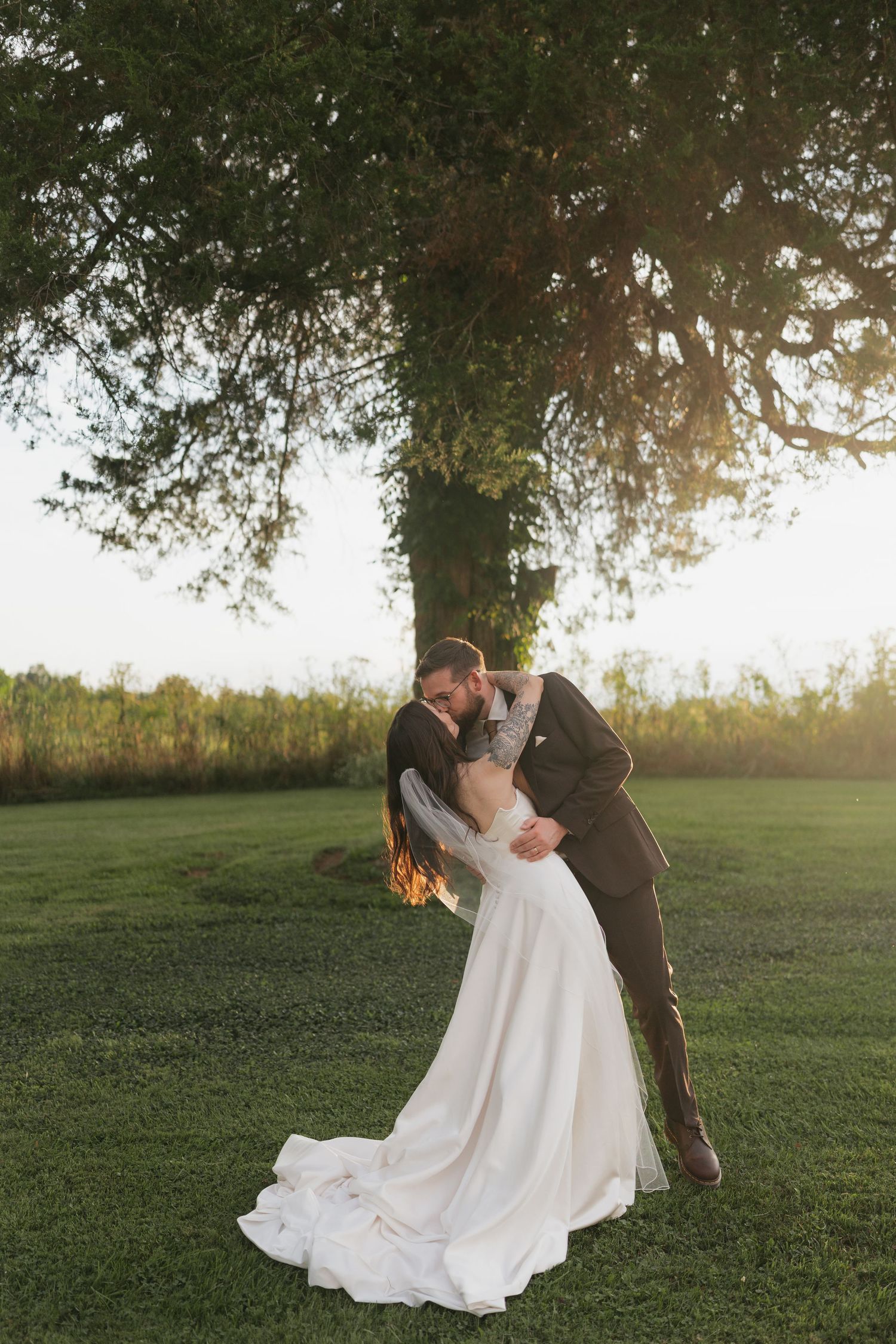 A couple exchanges vows in a scenic mountain meadow filled with wildflowers.
