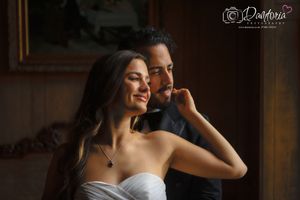 Romantic couple in elegant wedding attire sharing a tender moment, photographed by Pandoria Photography.