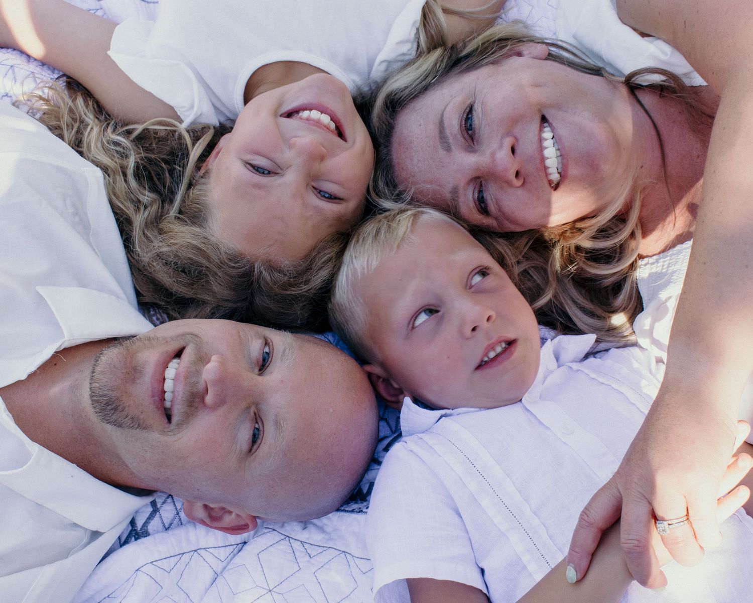 A sequence of five close-up photos showing joyful expressions and laughter while lying down.