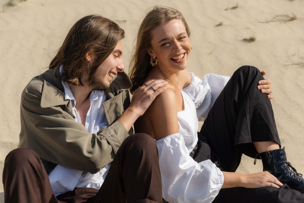 A man is holding a woman at the seaside.