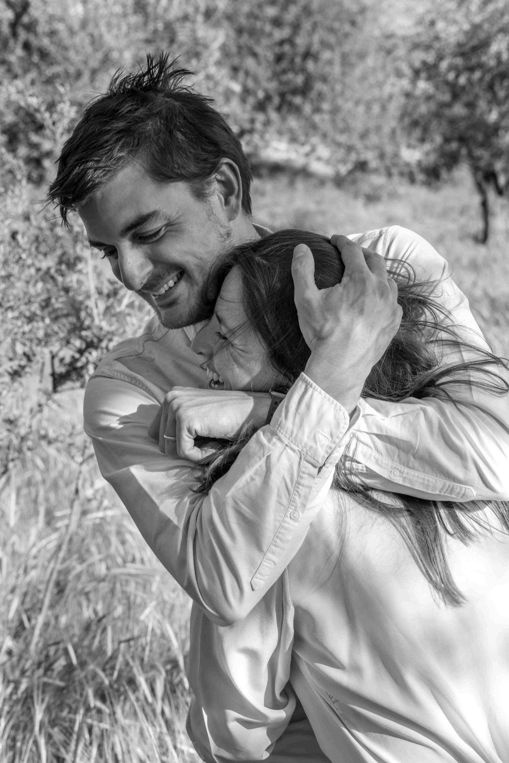A man hugs a woman.
