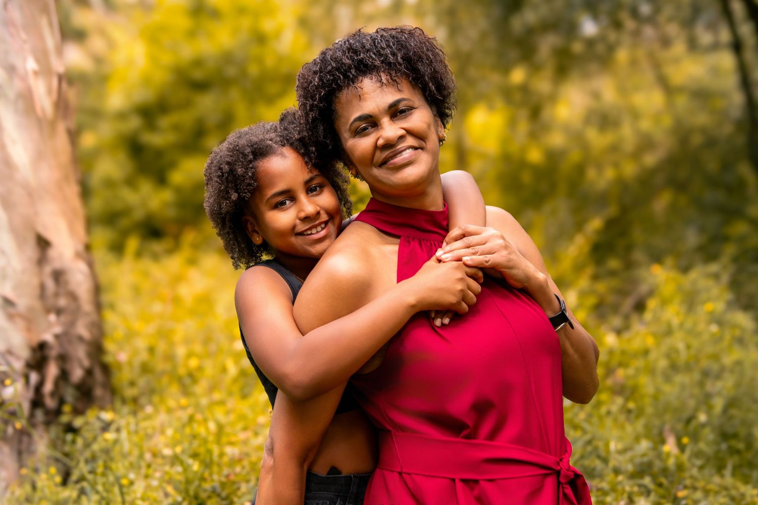 Joyful outdoor family photos taken in field with golden sunlight.