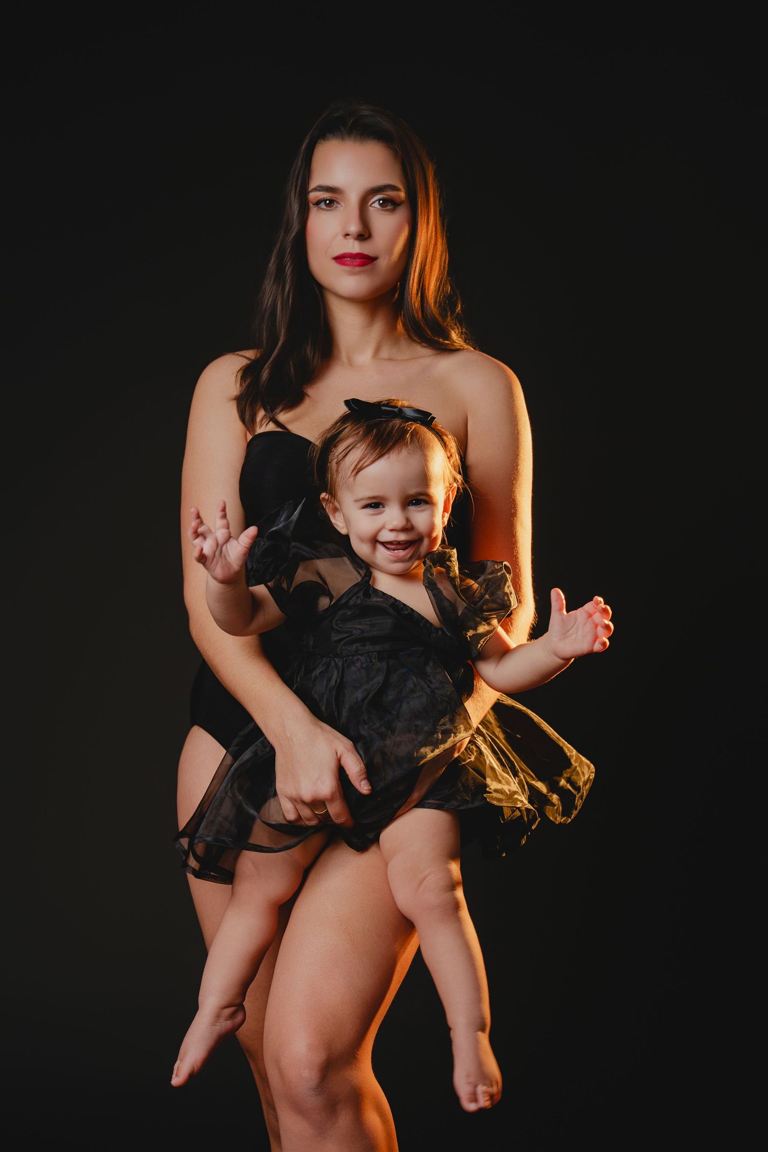 Dark and dramatic portrait session with warm accent lighting.
