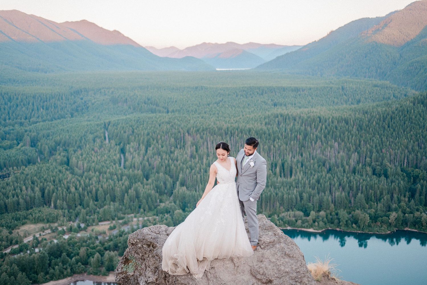 couple in wedding attire on top of Rattlesnake Ledge in Washington.