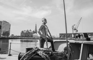 a photo of a sexy men during a sexy photo shoot, also called a boudoir photo shoot, in which she expresses selflove