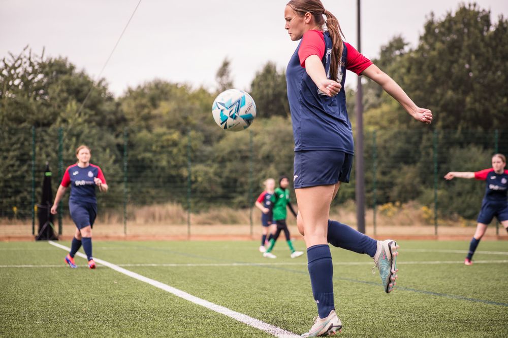 Chesting the football at a Kingfisher football game at Trinity High School in Redditch, photography by Holly CH Photography