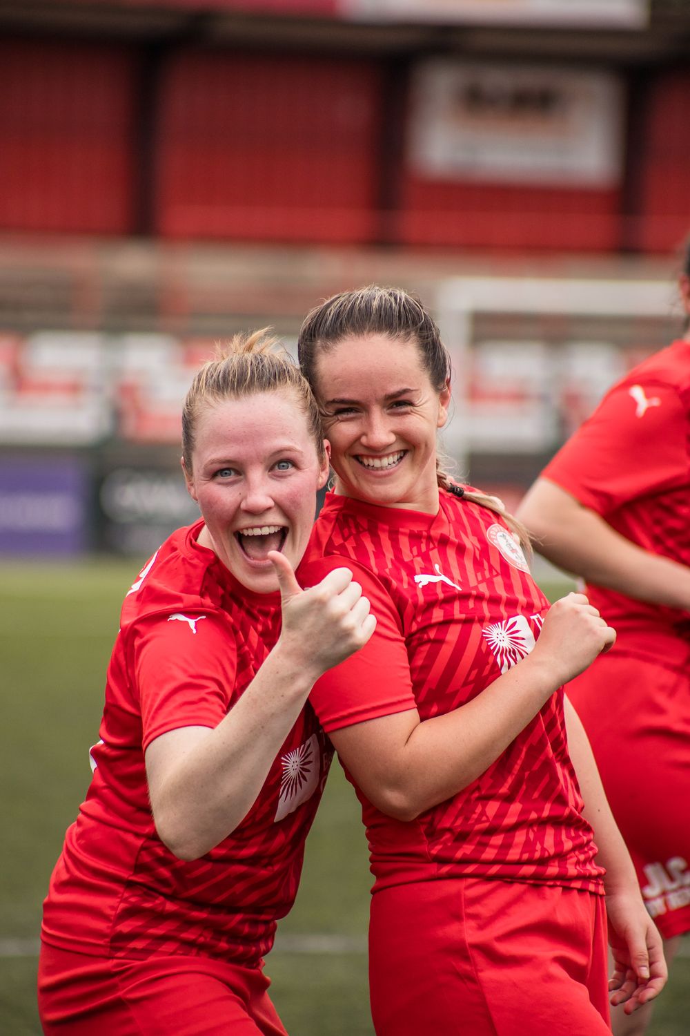 Two happy Redditch Utd Women players celebrating after an FA Cup victory