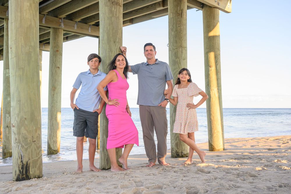Panoramic series of beach photos under a pier at sunset.