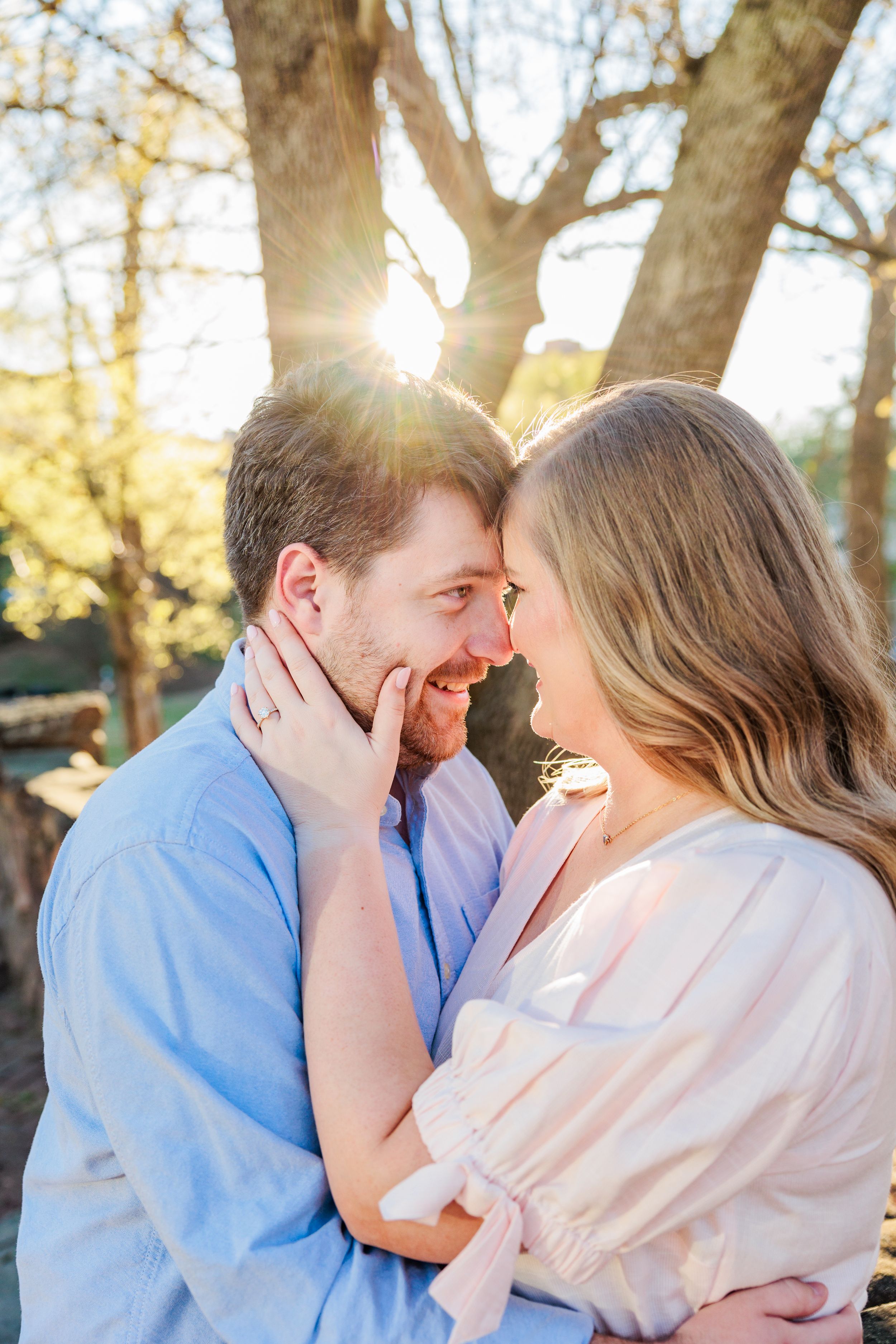 Romantic sunset portrait with golden light filtering through trees.