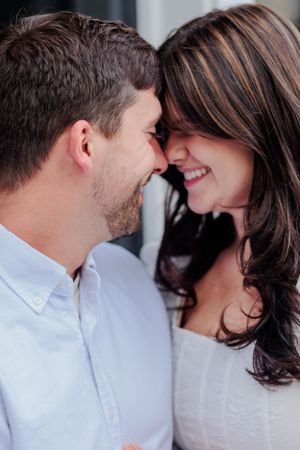 Intimate close-up moment between couple sharing laughter.