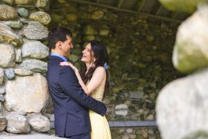 A wedding couple looking into each other's eyes in a stone foundation building.