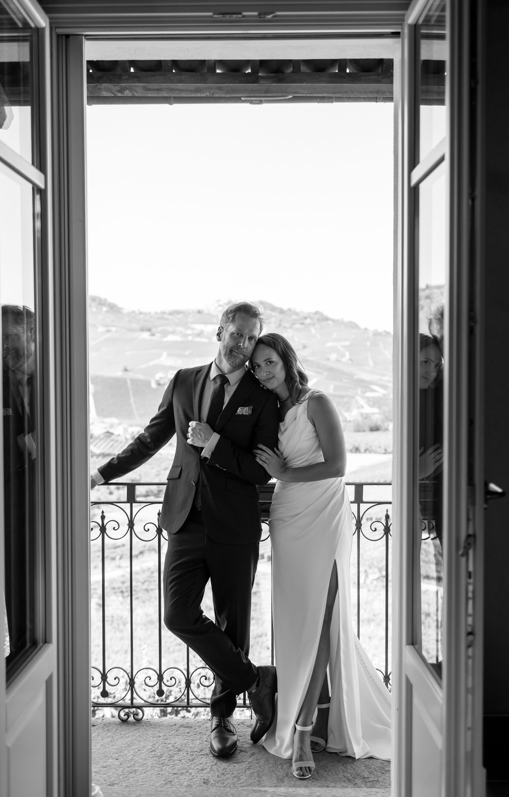 Black and white triptych of a romantic couple sharing intimate moments on an elegant balcony overlooking a scenic view.