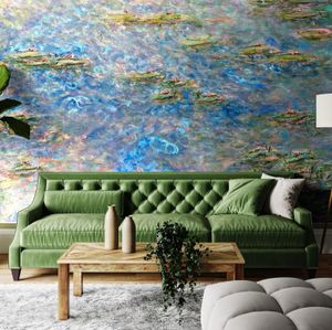 Modern living room with green tufted sofa, wooden coffee table and Monet-inspired water lily wall mural in blue tones.
