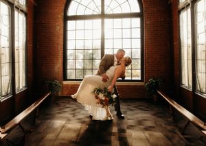 High-contrast indoor portrait at a  wedding venue with dramatic window lighting by L. Ballenger Photography, Branson Mo, Photographer.